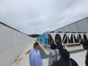 An image of a bank of smaller heat exchange compressors at the Edged Tilford Yard facility in Atlanta, GA with a group of those on the tour and those giving the tour.